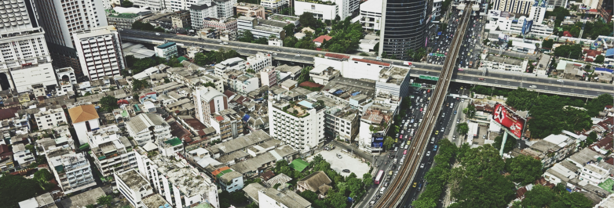 Aerial photograph of a smart city showing major trunk roads, intersections and flyovers in the middle of a city.